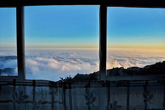 Sunrise view of sea of clouds through window