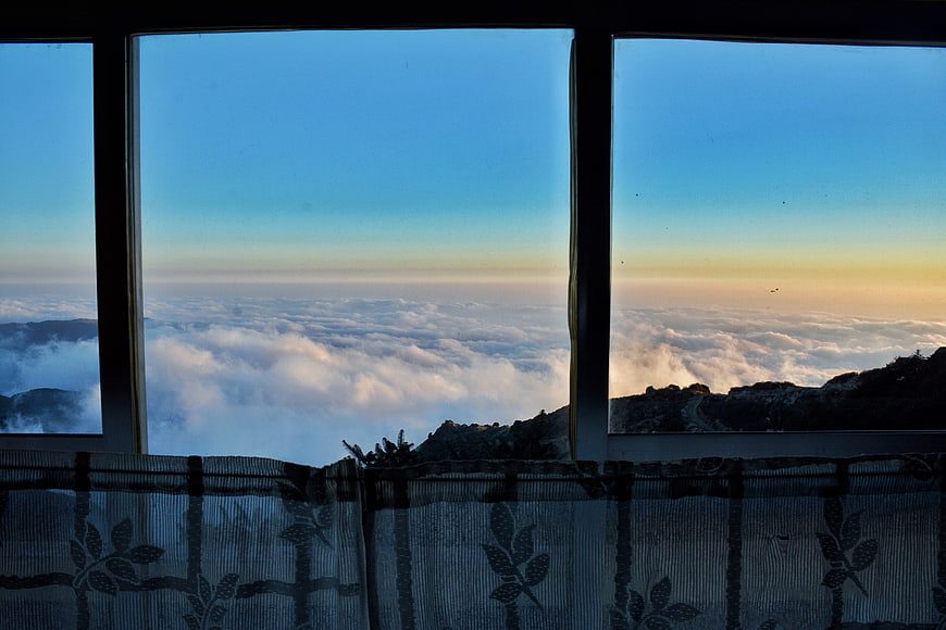 Sunrise view of sea of clouds through window