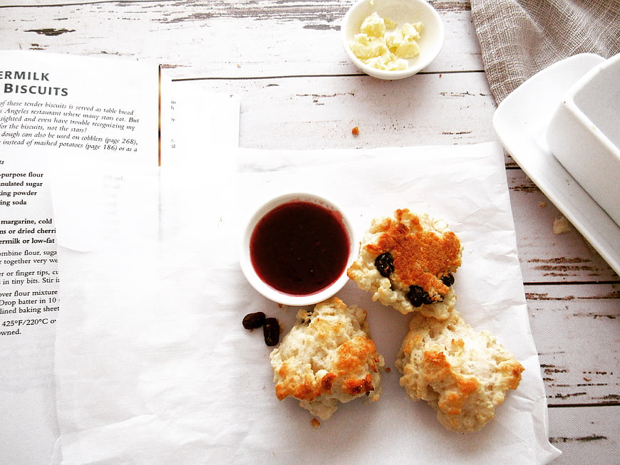 Freshly Baked Biscuits with Jam and Butter on White Table