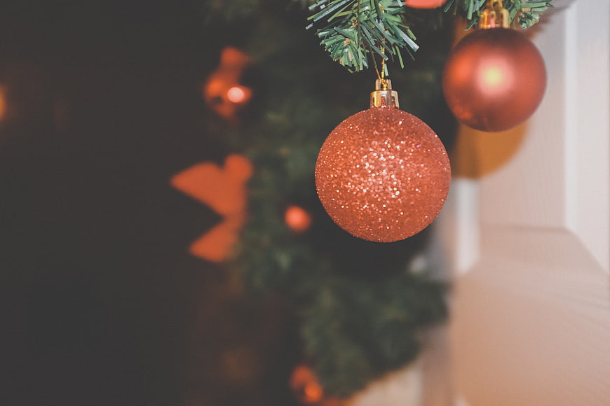 Close-up of Glittery Red Christmas Bauble on Tree