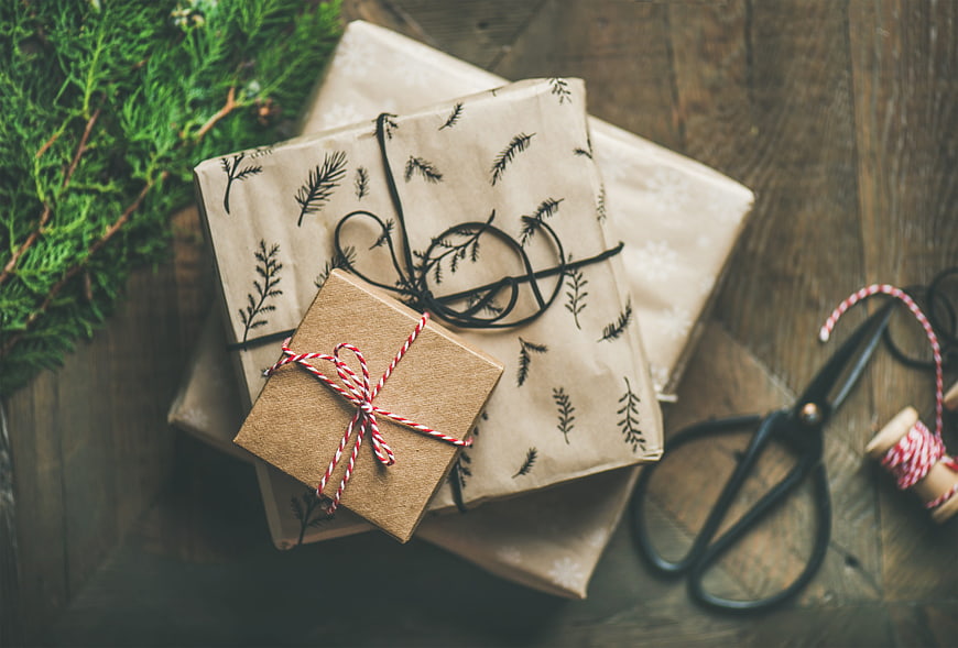 Rustic Christmas gifts wrapped in kraft paper on wooden table