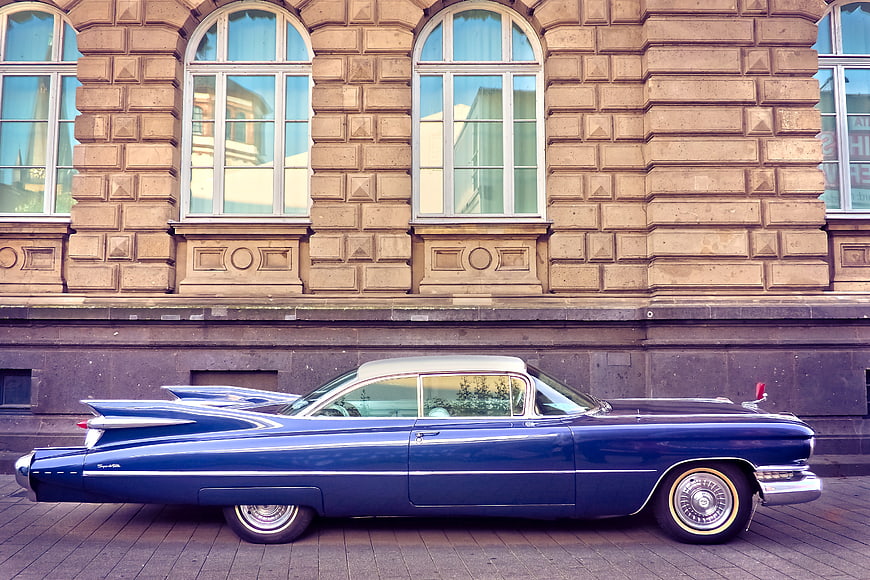 Vintage Blue Cadillac Coupe de Ville Parked on Street