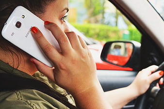 Woman Driving Car While Talking on Smartphone
