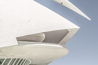 Low angle view of modern white concrete architecture against blue sky