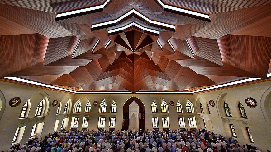 Interior of Somuncubaba Mosque with Geometric Wooden Ceiling and Congregation