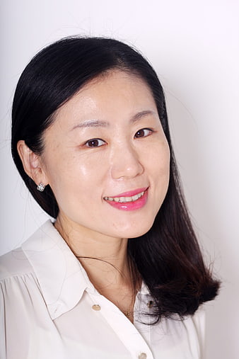 Portrait of smiling Asian woman in white shirt