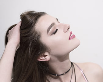 Close-up portrait of beautiful woman with hand in hair