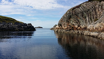 Scenic Norwegian Fjord with Rocky Cliffs and Calm Blue Water