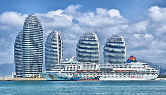 White Cruise Ship Docked Near Iconic Sanya Phoenix Island Towers