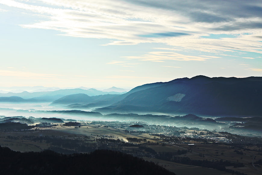 Misty Mountain Valley Landscape with Fog and Clouds