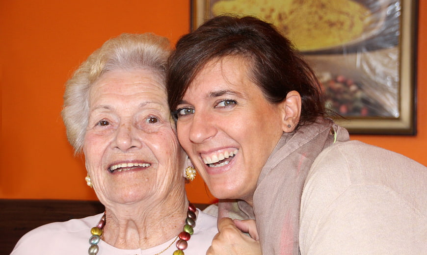 Happy Senior Woman and Younger Woman Laughing Together