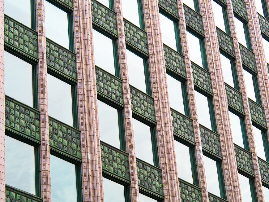 Modern building facade with green geometric tile patterns