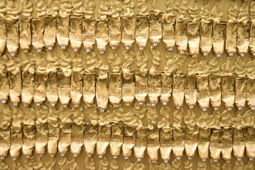 Abstract Pattern of Gold Paint Tubes and Squeezed Texture