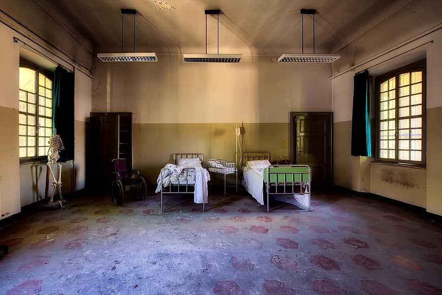 Abandoned Hospital Room with Skeleton and Vintage Medical Beds