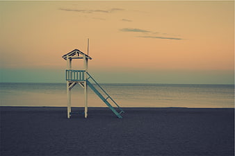 Solitary Lifeguard Tower on Empty Beach at Sunset
