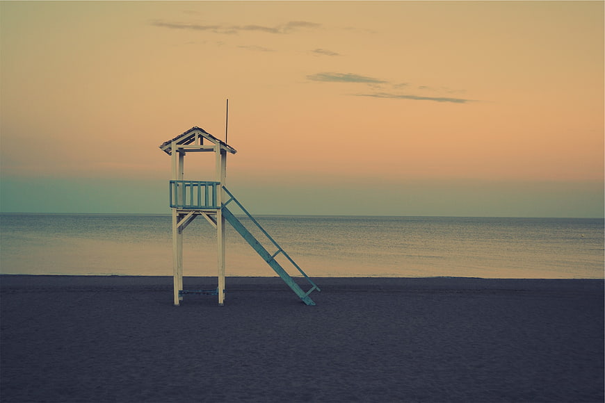 Solitary Lifeguard Tower on Empty Beach at Sunset