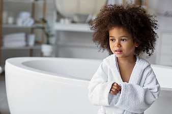 Cute Child in White Bathrobe Standing in Modern Bathroom
