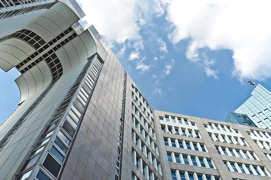 Low Angle View of Modern High-Rise Architecture Against Blue Sky