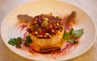 Gourmet chili con carne and rice dish with beans and garnish