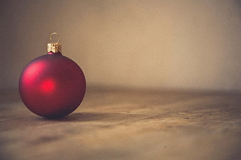Red Christmas Ornament on Wooden Surface with Copyspace