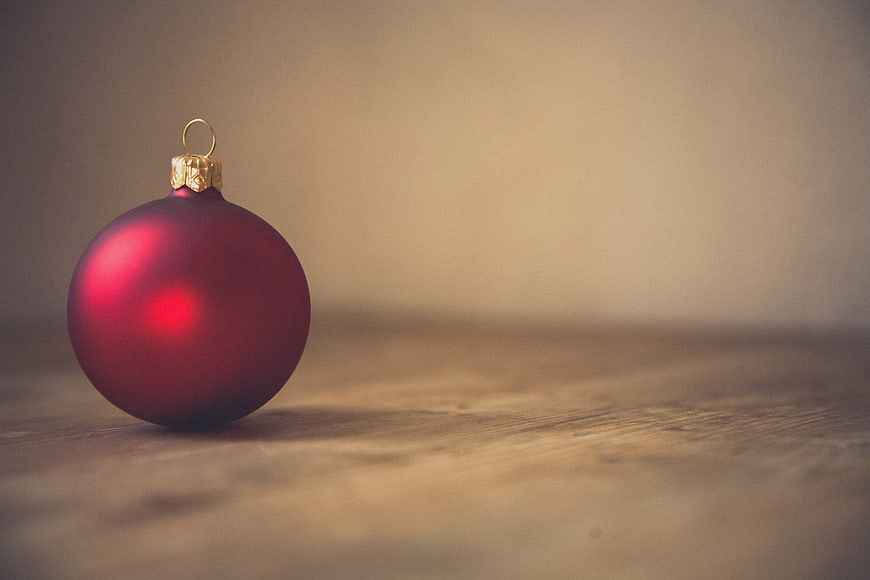 Red Christmas Ornament on Wooden Surface with Copyspace