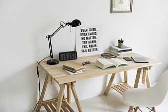 Minimalist wooden workspace with motivational quote and office supplies