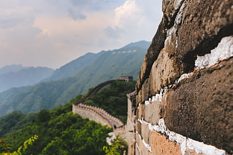 Great Wall of China winding through green mountains