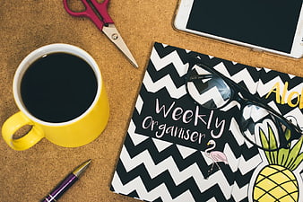 Flat Lay of Weekly Planner, Coffee, and Office Supplies