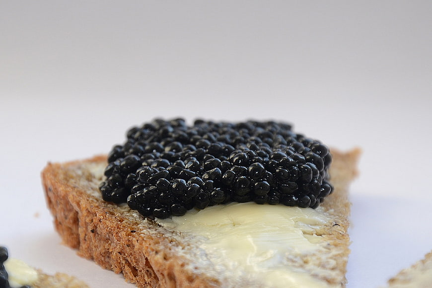 Close-up of black caviar on buttered toast