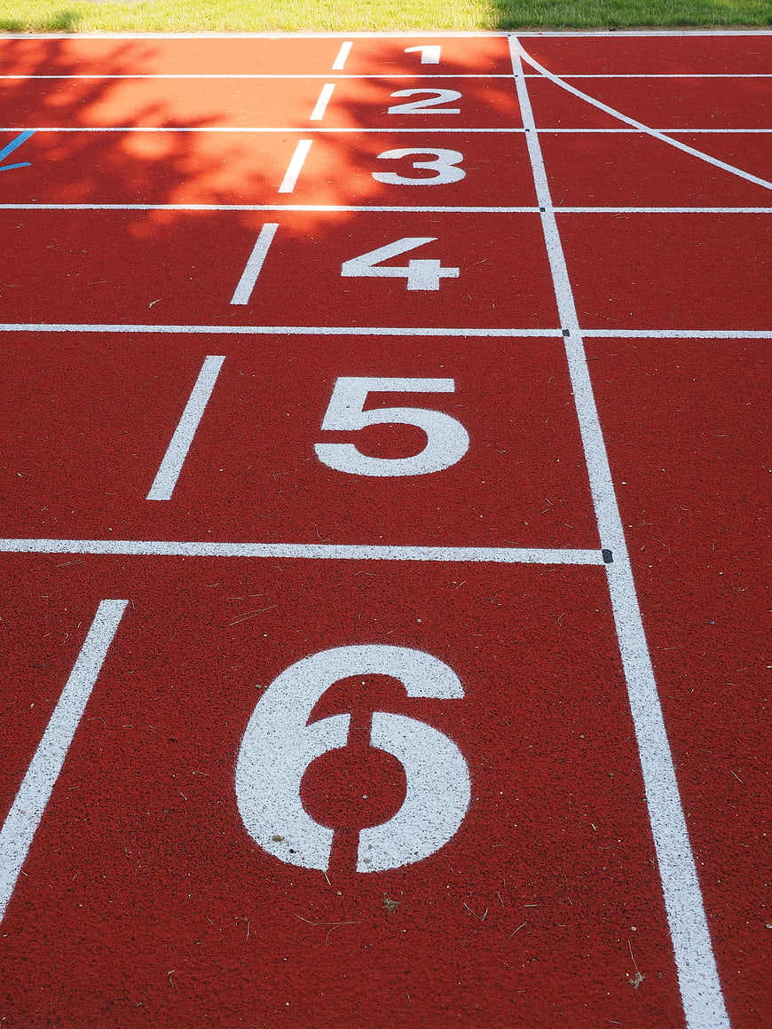Red Tartan Running Track With White Lane Numbers 1 To 6