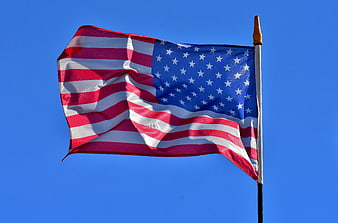 American Flag Waving Against Clear Blue Sky