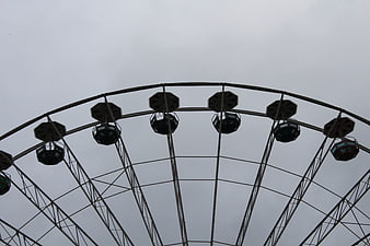 Ferris Wheel Structure Silhouette Against Overcast Gray Sky