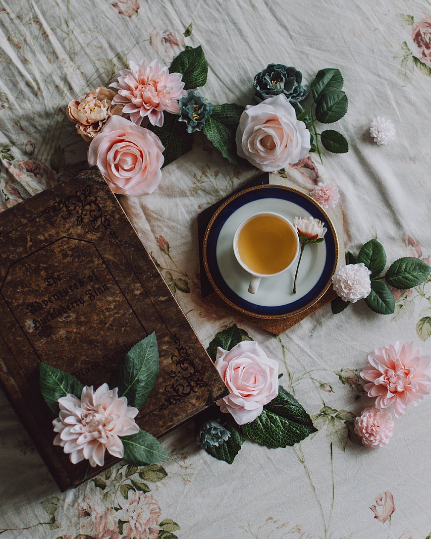 Vintage Book and Floral Tea Still Life on Floral Linen
