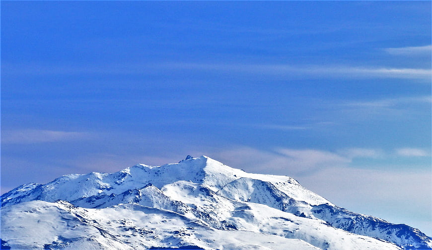 Snow-Capped Mountain Peak Against Blue Sky
