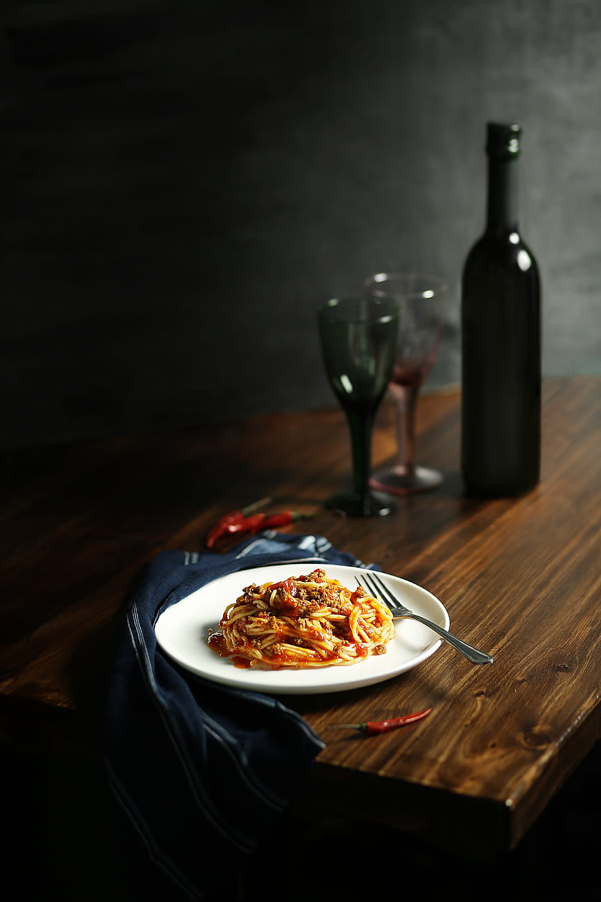 Spaghetti Bolognese with Wine on Rustic Wooden Table