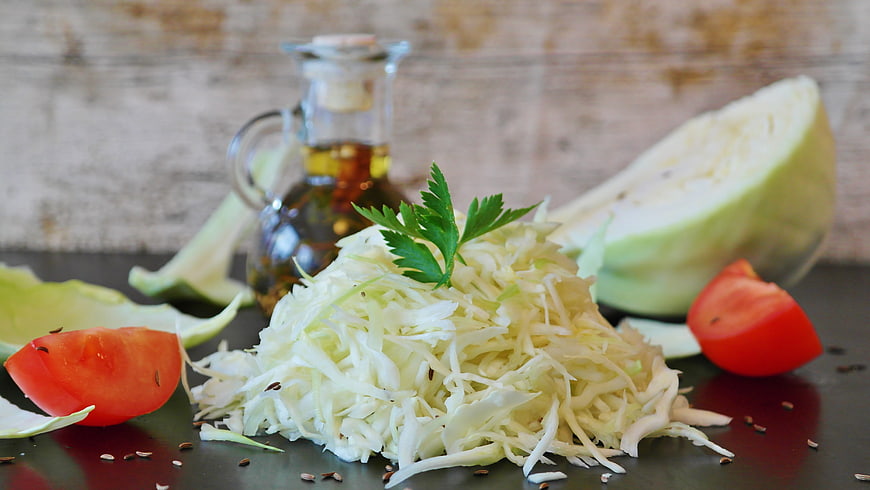 Fresh shredded white cabbage salad with tomatoes and oil