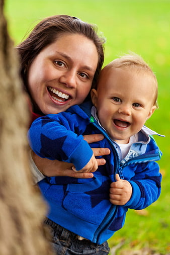 Happy Mother and Toddler Son Playing Outdoors