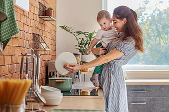 Mother Cooking with Toddler in Modern Kitchen
