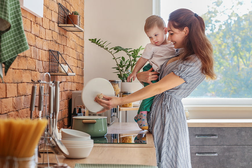 Mother Cooking with Toddler in Modern Kitchen