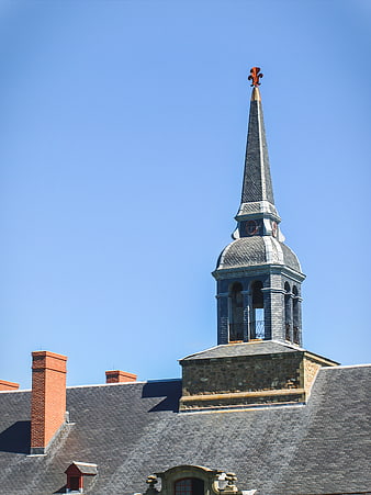 Historic church steeple against clear blue sky