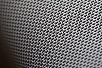 Close-up of perforated metal mesh texture background