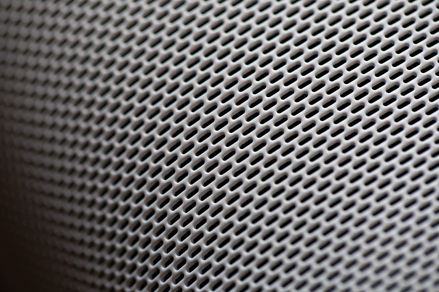 Close-up of perforated metal mesh texture background