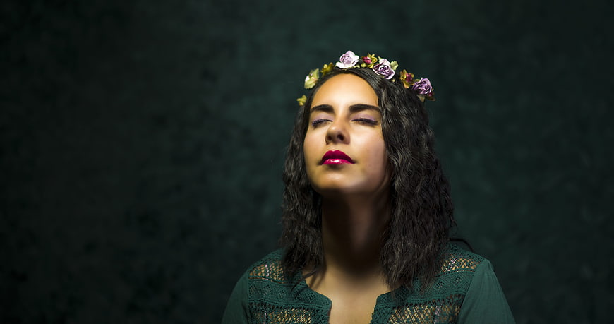 Portrait of young woman with flower crown and closed eyes