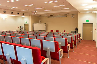 Empty University Lecture Hall with Red Chairs and Whiteboards