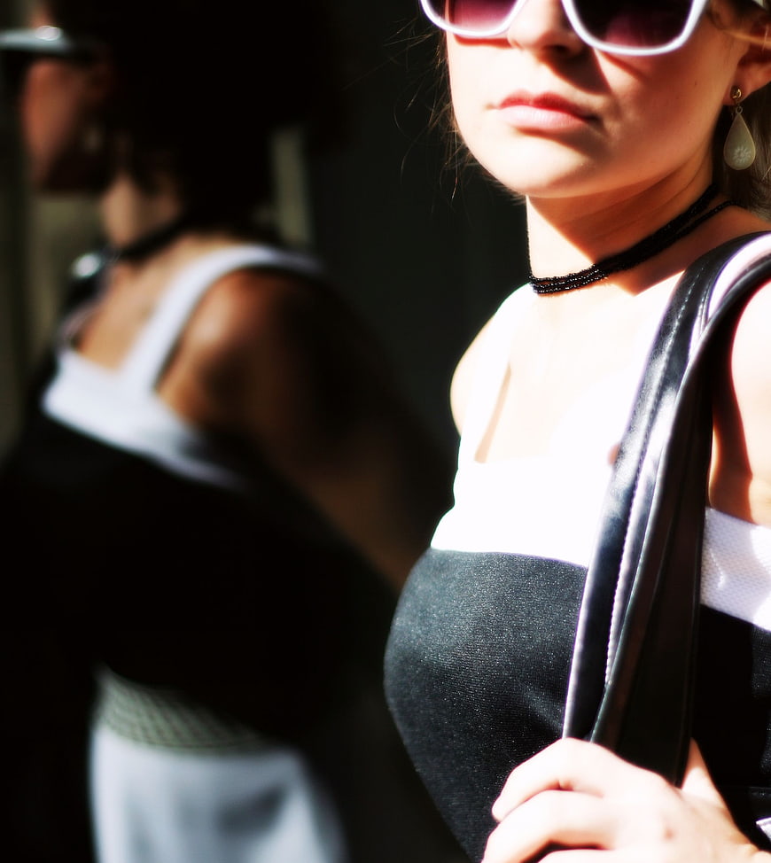 Close-up of stylish woman in sunglasses and black dress