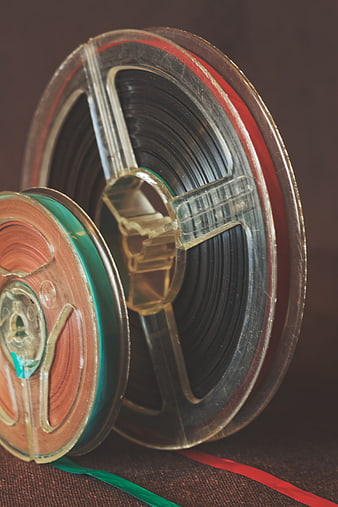 Vintage 35mm Film Reels and Strips on Textured Surface
