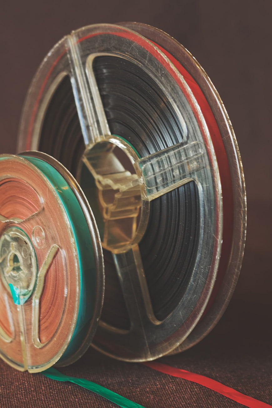 Vintage 35mm Film Reels and Strips on Textured Surface