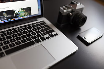 Laptop, Vintage Camera, and Smartphone on Dark Desk