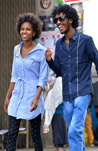 Happy African American Couple Walking and Smiling Outdoors