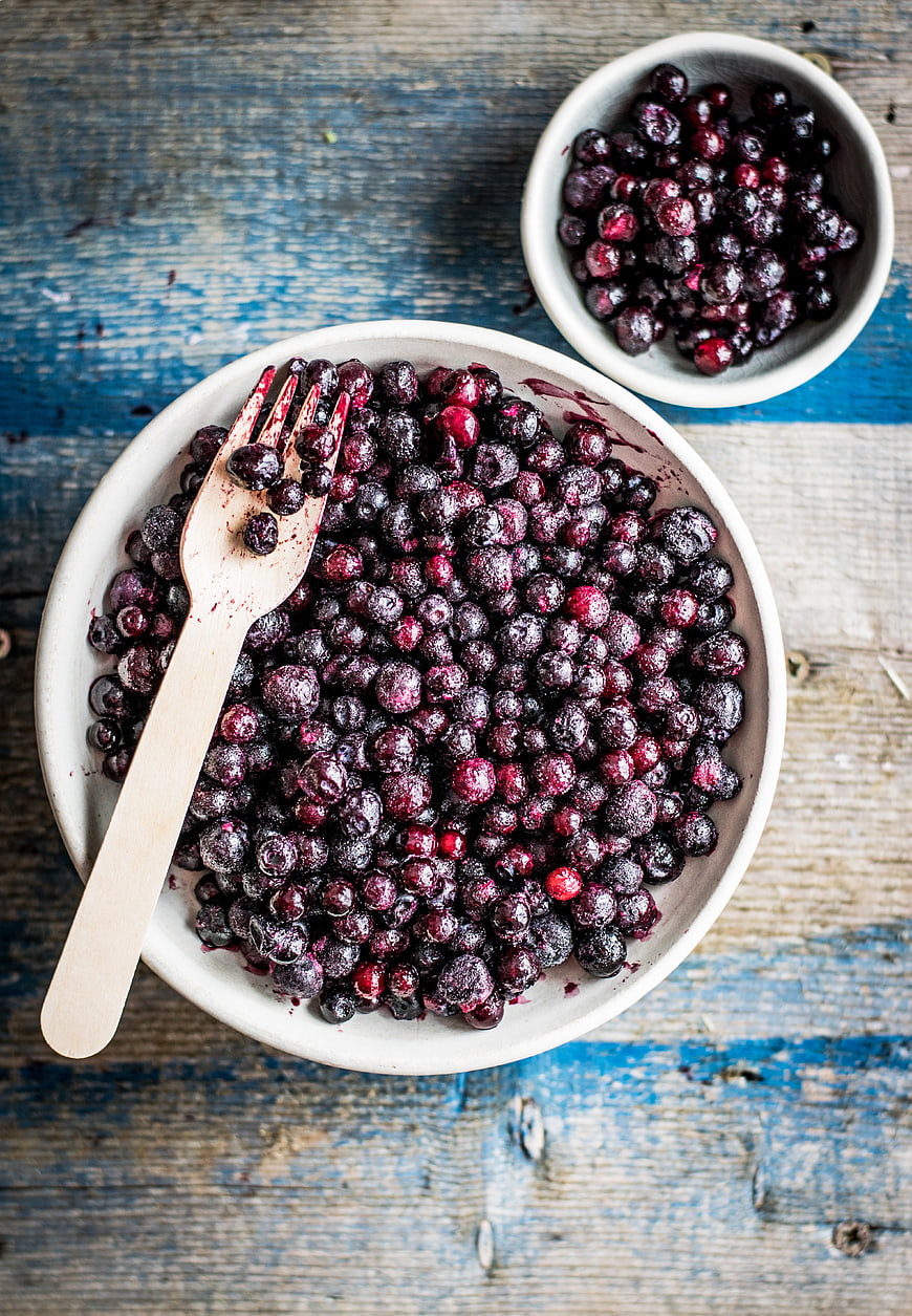 Top View of Frozen Wild Blueberries in Ceramic Bowl
